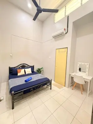 a bedroom with a bed and a desk at QM_Homestay Bagan Serai in Bagan Serai