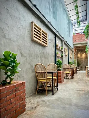 a group of chairs and tables in a patio at DoSomething Guest House 2 in Ipoh