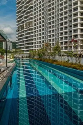 a large swimming pool in front of a tall building at Deluxe Seaview Suite King Bed by The Only Bnb in Tanjong Tokong