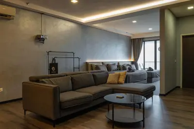 a living room with a couch and a table at Luxury Seaview Projector Lounge by The Only Bnb in Tanjong Tokong