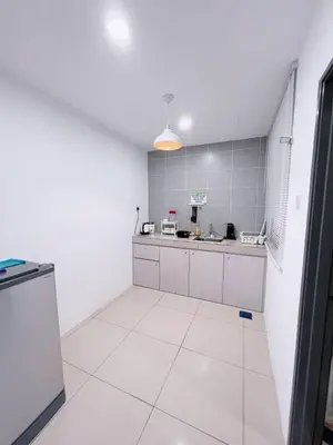 a large white kitchen with a sink and a counter at Manhanttan Ipoh Waterpark Homestay By Warmth Stay 4-7pax 3BR in Ipoh