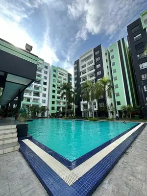 a large swimming pool in front of some buildings at Manhanttan Ipoh Waterpark Homestay By Warmth Stay 4-7pax 3BR in Ipoh