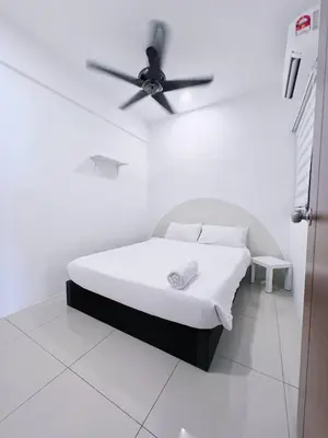 a bedroom with a bed with a ceiling fan at Manhanttan Ipoh Waterpark Homestay By Warmth Stay 4-7pax 3BR in Ipoh