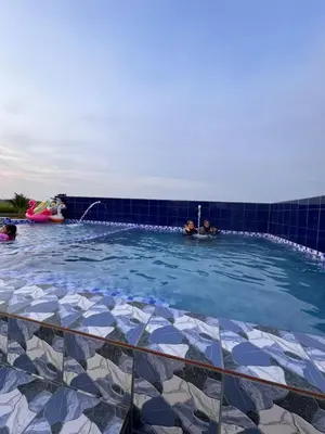 a group of people in a swimming pool at Laman D'Arni in Sungai Besar