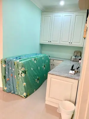 a kitchen with a green suitcase in the corner at Puncak Villa 10-20pax in Kuala Kangsar