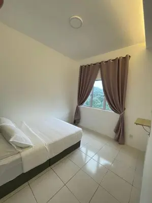 a bedroom with a bed and a window at Biella Homestay Apartment for Muslim in Tanah Rata
