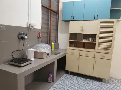 a kitchen with blue cabinets and a counter top at Homestay Taman Mas, Kg Koh in Sitiawan