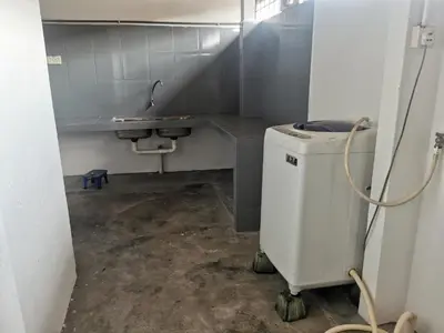 a bathroom with a sink and a washing machine at Homestay Taman Mas, Kg Koh in Sitiawan