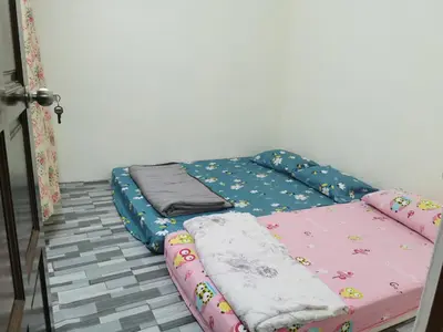 a bed in a room with two mattresses on it at Homestay Taman Mas, Kg Koh in Sitiawan