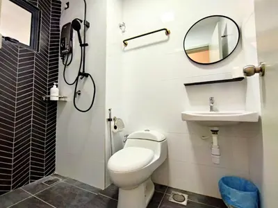a bathroom with a toilet and a sink and a mirror at The Horizon Ipoh Stay by Grab A Stay in Ipoh