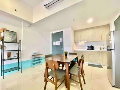a kitchen and dining room with a table and chairs at Tropicana 218 Macalister #Top Floor #WideAngleViews #InfinityPool #Georgetown #8pax #3BR 2bath #2Queen 4Single #Near island hospital #Quality well maintained #Private host in George Town