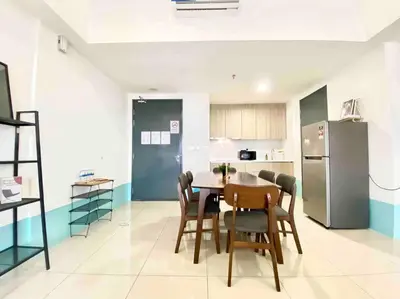 a kitchen with a table and chairs and a refrigerator at Tropicana 218 Macalister #Top Floor #WideAngleViews #InfinityPool #Georgetown #8pax #3BR 2bath #2Queen 4Single #Near island hospital #Quality well maintained #Private host in George Town