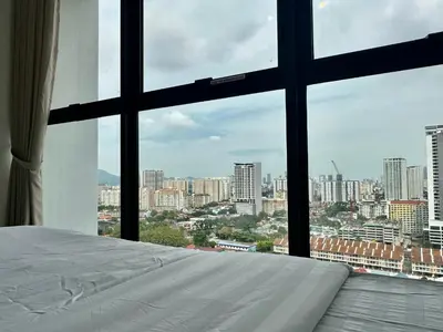 a bedroom with a view of a city from a window at Urban Suites Georgetown by BNB4U in Jelutong