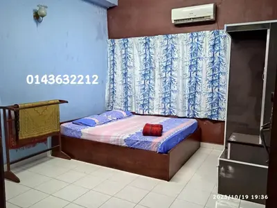 a small bed in a room with a curtain at Ekaira homestay in Tambun