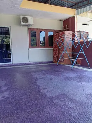 an empty room with a door and a building at Ekaira homestay in Tambun