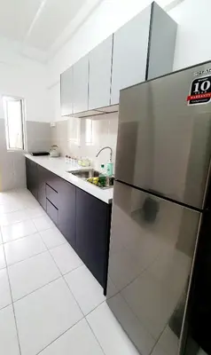 a kitchen with a stainless steel refrigerator in it at Balcony Forest Lake Mountain in Kampar