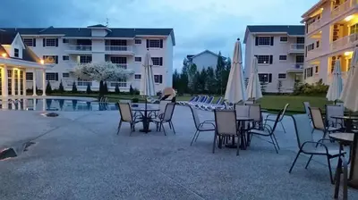 a patio with a table with chairs and umbrellas at The Trails of Kampar in Kampar