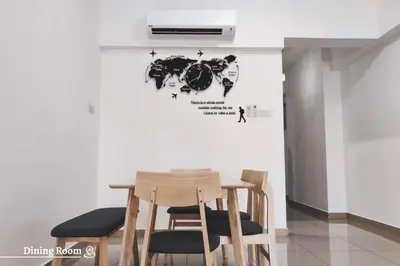 a table and chairs with a world map on a wall at Time Homestay (6-8pax) The Venus, Manjung/Sitiawan in Sitiawan