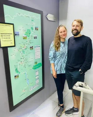 a man and a woman standing next to a map at BRICKS Cameron Hostel in Tanah Rata