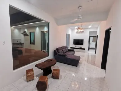 a living room with a couch and a table at Kulim Mini HomeStay in Kulim