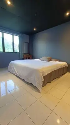 a bedroom with a large bed in a room at Coral Bay \u5c0f\u578b\u516c\u5bd3 in Pasir Bogak
