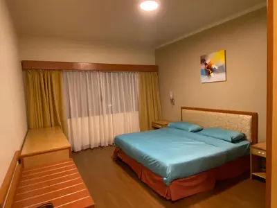 a hotel room with a bed and a window at COZY HOME COPTHONE RESORT in Brinchang