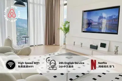 a living room with a flat screen tv on a wall at The Beacon Executive Penang Georgetown in George Town