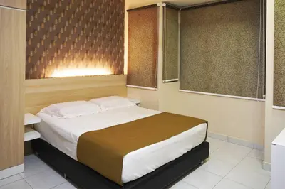 a bedroom with a large bed and two windows at Taiping Modern Home in Kamunting