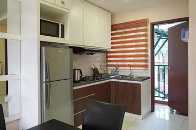 a kitchen with a stainless steel refrigerator and a microwave at Taiping Modern Home in Kamunting