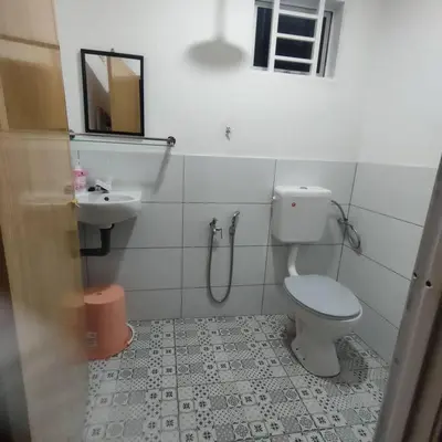 a bathroom with a toilet and a sink at Kampung Cottage Bagan Datuk in Selekoh