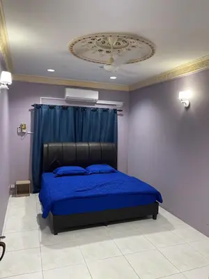 a bedroom with a blue bed and a ceiling at Thumbs Up HomeStay in Kampong Jalan Berop