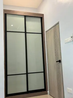 a room with a sliding glass door next to a wall at Tambun Hillview Cottage 2 in Ipoh