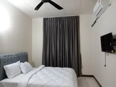 a bedroom with a white bed with a ceiling fan at BUTTERWORTH RAJA UDA RAYA HOMESTAY in Butterworth