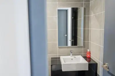 a bathroom with a sink and a mirror at Ipoh Tambun Lost World Sunway Onsen Mina 3R2B 8pax in Tambun
