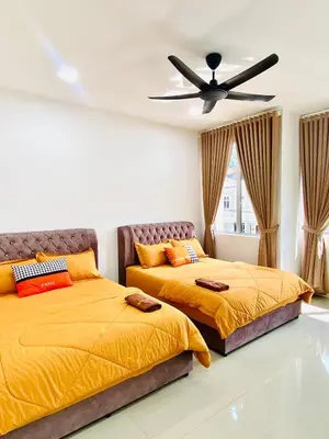 two beds in a bedroom with a ceiling fan at LH SUITE HOMESTAY Gua Musang- Masjid Mekah in Gua Musang