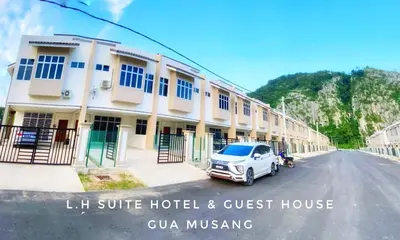 a car parked in front of a hotel and guest house at LH SUITE HOMESTAY Gua Musang- Masjid Mekah in Gua Musang