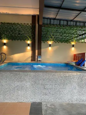 a swimming pool with blue water in a building at Impiana Pool House Seri Manjung in Seri Manjung