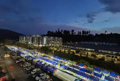 a parking lot filled with lots of tents and parked cars at G Residence - 2R2B Barrington Night Market (1) in Brinchang