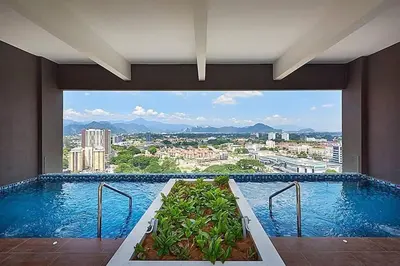 a large swimming pool with a view of a city at The Horizon Ipoh Infinity Pool 5 to 9pax in Ipoh