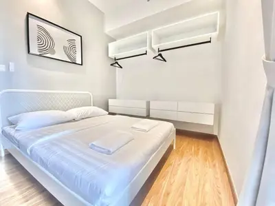 a white bedroom with a white bed in a room at Beacon Executive Suites #Minimalist #SkyPool #Georgetown #6pax #2BR 2bath #3 Queen #Quality well maintained #Private host in George Town