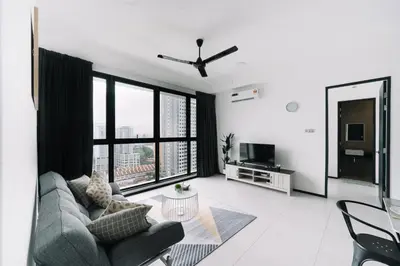 a living room with a couch and a large window at NEW Infinity Pool 3 Bedrooms 2 Carparks 197 in Jelutong