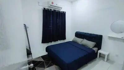 a blue bed in a room with a window at FIRASH HOMESTAY AT SERI ISKANDAR in Seri Iskandar