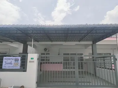 a gas station with a gate and a refrigerator at FIRASH HOMESTAY AT SERI ISKANDAR in Seri Iskandar