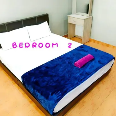 a bed with a blue blanket on top of it at Muslim Suite Home @ Airport Bayan Lepas Penang in Bayan Lepas