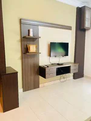 a living room with a tv and a tv stand with a television at Qaseh Homestay Cameron Highlands 3 in Brinchang
