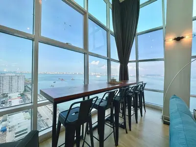a table and chairs in a room with a large window at Maritime Suite #Full Seaview #Pool Table #Hot Water Dispenser #Kids friendly #Georgetown #6pax #2BR2bath #Private host in Jelutong