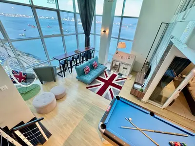 a pool table in a room with a view of the ocean at Maritime Suite #Full Seaview #Pool Table #Hot Water Dispenser #Kids friendly #Georgetown #6pax #2BR2bath #Private host in Jelutong