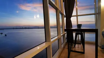 a room with a table and a view of the water at Maritime Suite #Full Seaview #Pool Table #Hot Water Dispenser #Kids friendly #Georgetown #6pax #2BR2bath #Private host in Jelutong