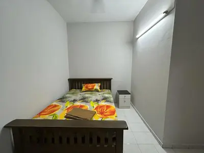 a bedroom with a bed in a white room at Muhibbah Homestay in Sungai Siput