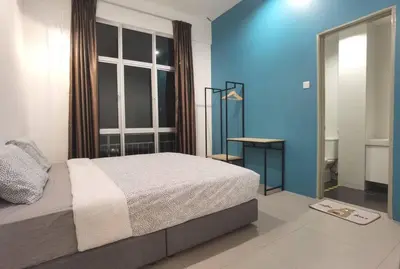a bedroom with a bed and a blue wall at G Residence - 2R2B Barrington Night Market (2) in Brinchang